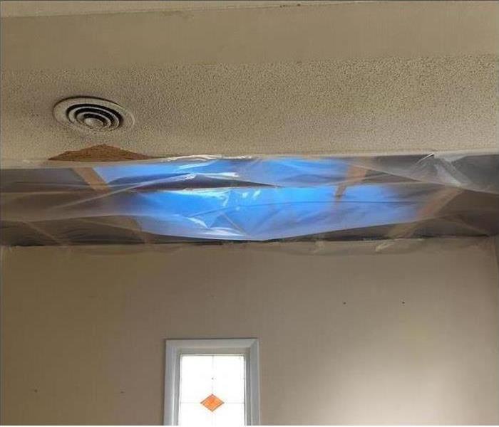 Containment plastic over hole in ceiling